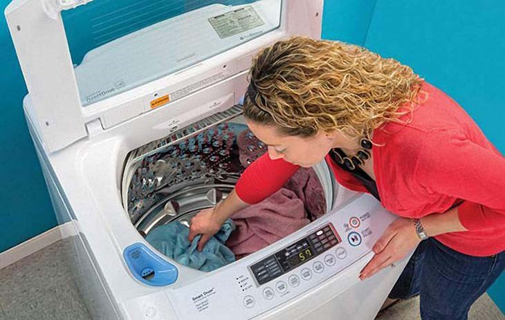 lấy quần áo ra khỏi máy giặt